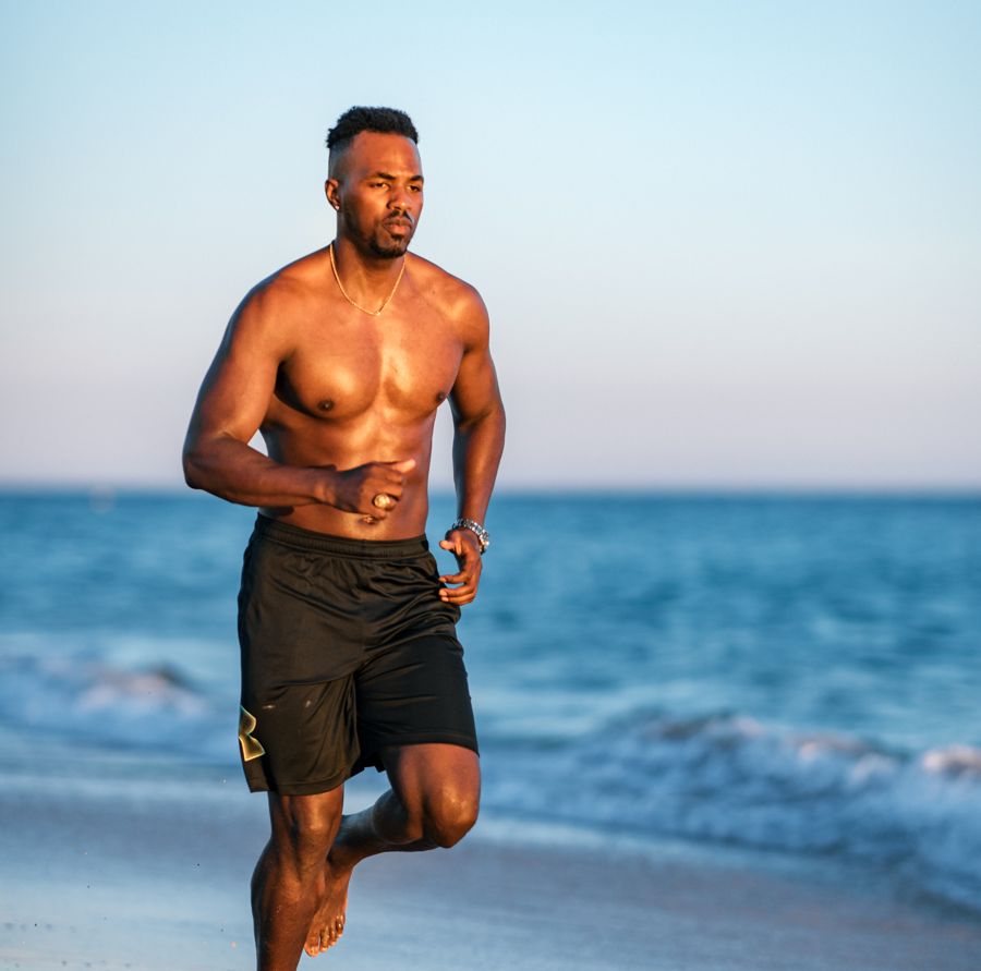 Tino Jalo running on a beach